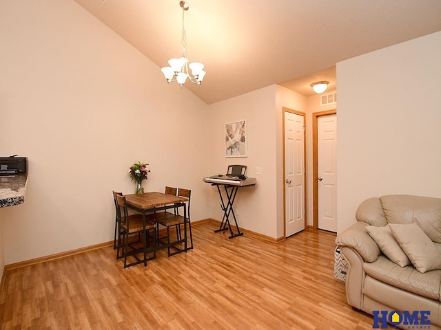 8946 Broken Spoke Dr, Lincoln, NE 68507 - dining area featuring light wood-type flooring, a chandelier, baseboards, and vaulted ceiling