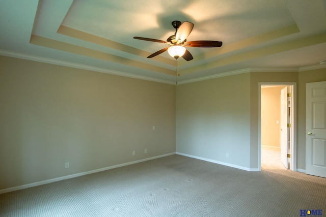 9160 Pioneer Ct, Lincoln, NE 68520 - carpeted spare room featuring a raised ceiling, a ceiling fan, baseboards, and crown molding