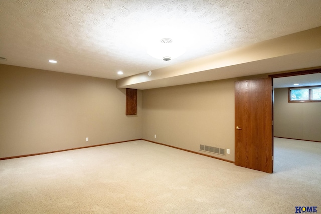 9160 Pioneer Ct, Lincoln, NE 68520 - below grade area with carpet, baseboards, a textured ceiling, and recessed lighting