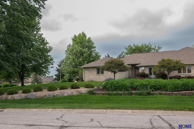 9160 Pioneer Ct, Lincoln, NE 68520 - view of property exterior featuring a lawn and brick siding