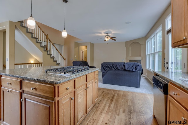 6732 S 169th Ave, Omaha, NE 68135 - kitchen featuring stainless steel appliances, light wood-style flooring, a ceiling fan, dark stone countertops, and hanging light fixtures