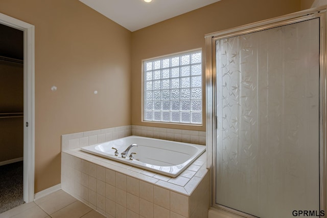 6732 S 169th Ave, Omaha, NE 68135 - bathroom with a garden tub, tile patterned floors, a stall shower, a spacious closet, and baseboards