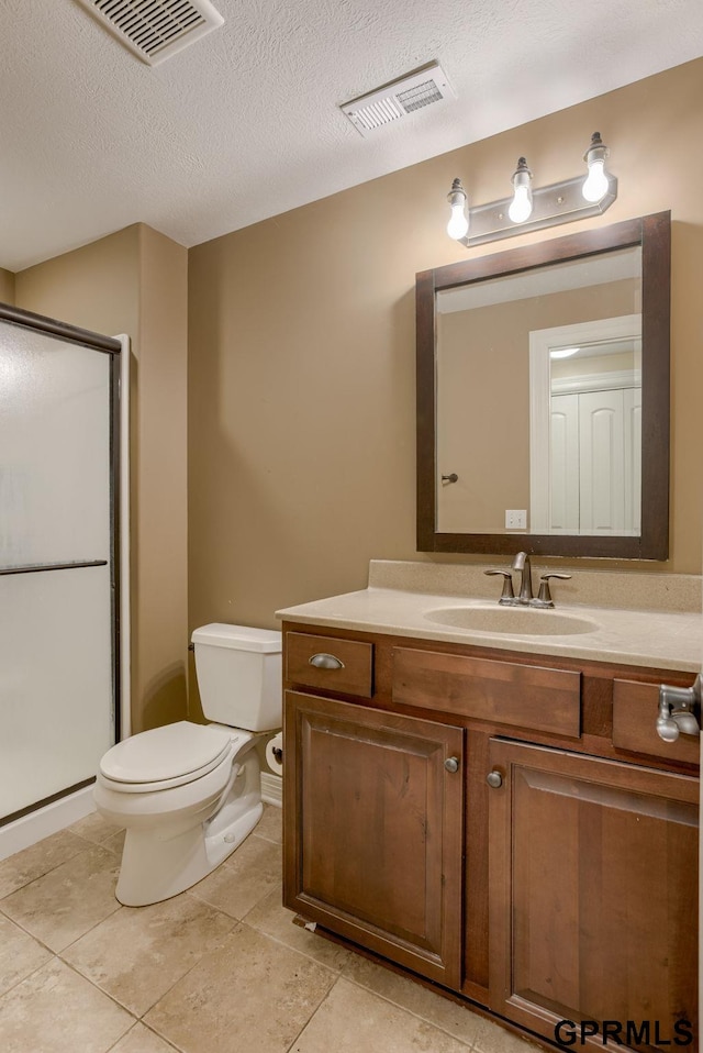 6732 S 169th Ave, Omaha, NE 68135 - full bathroom with toilet, vanity, a stall shower, tile patterned floors, and a textured ceiling