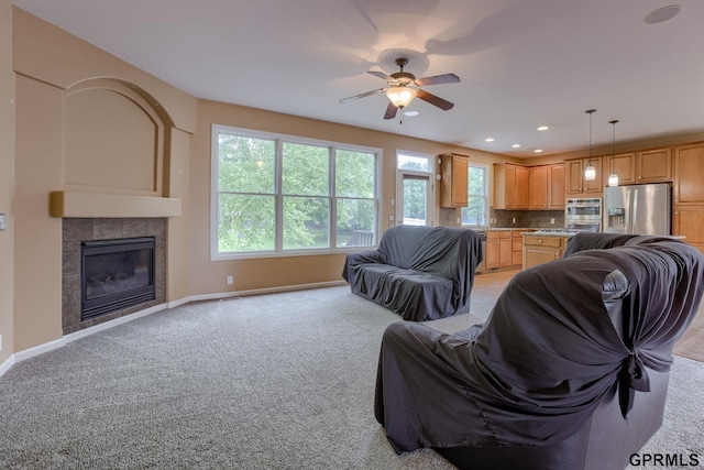 6732 S 169th Ave, Omaha, NE 68135 - living room with ceiling fan, light colored carpet, baseboards, a tiled fireplace, and recessed lighting