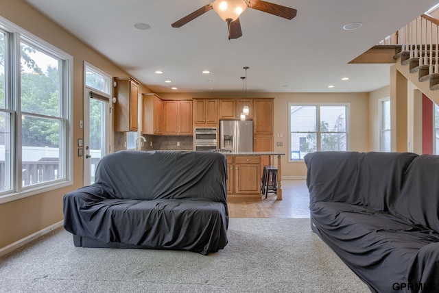 6732 S 169th Ave, Omaha, NE 68135 - living area with baseboards, ceiling fan, stairs, recessed lighting, and light carpet
