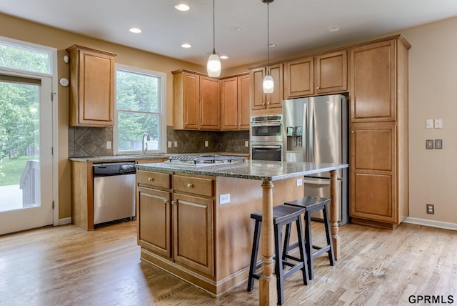 6732 S 169th Ave, Omaha, NE 68135 - kitchen with appliances with stainless steel finishes, a kitchen island, healthy amount of natural light, light wood-style floors, and recessed lighting