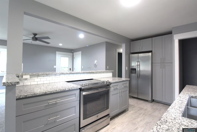 1425 Meadow Dale Dr, Lincoln, NE 68505 - kitchen with appliances with stainless steel finishes, gray cabinetry, light wood-style flooring, ceiling fan, and recessed lighting