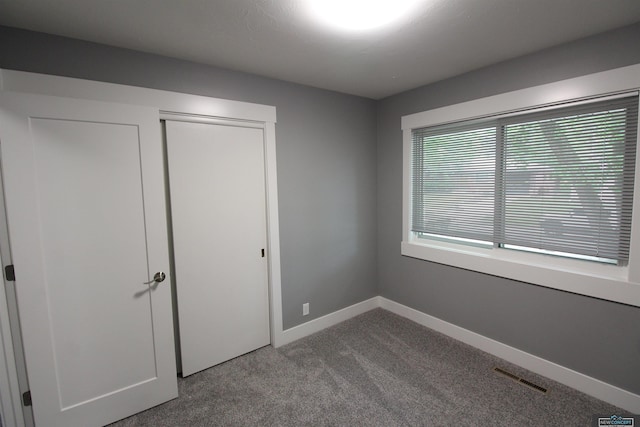1425 Meadow Dale Dr, Lincoln, NE 68505 - unfurnished bedroom with carpet flooring, baseboards, and a closet