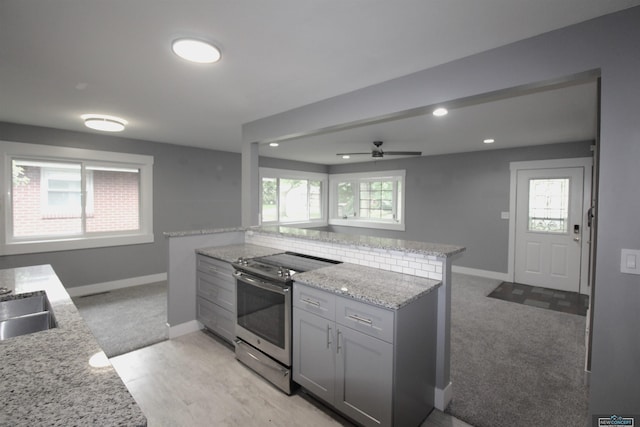 1425 Meadow Dale Dr, Lincoln, NE 68505 - kitchen featuring stainless steel range with electric cooktop, light carpet, gray cabinets, light stone counters, and a ceiling fan