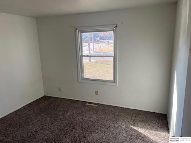 carpeted empty room with baseboards