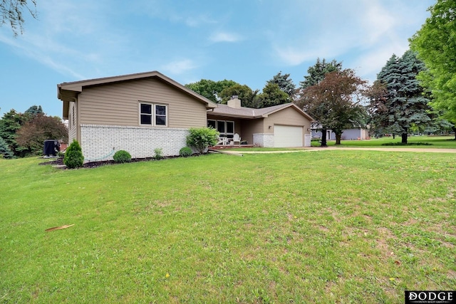 1131 Elizabeth Cir, Fremont, NE 68025 - single story home with brick siding, a garage, concrete driveway, and a front yard