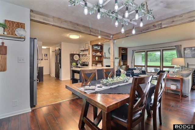 1131 Elizabeth Cir, Fremont, NE 68025 - dining room with beamed ceiling, a chandelier, wood finished floors, and baseboards