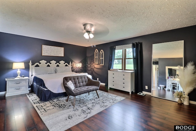 1131 Elizabeth Cir, Fremont, NE 68025 - bedroom with a textured ceiling, hardwood / wood-style floors, baseboards, and ceiling fan