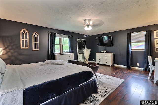 1131 Elizabeth Cir, Fremont, NE 68025 - bedroom featuring a textured ceiling, dark wood-style floors, and baseboards