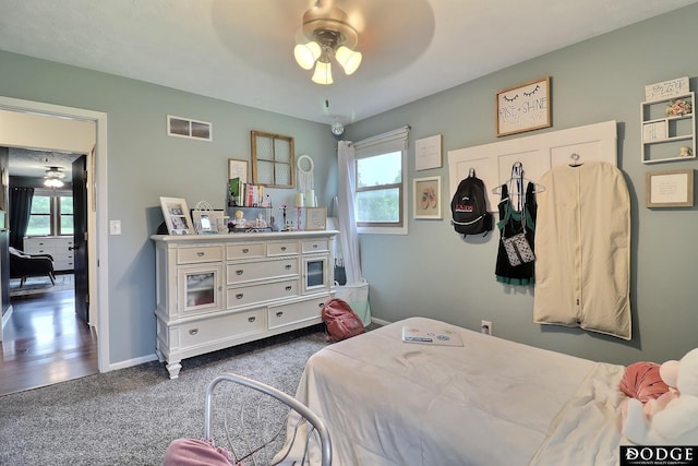 1131 Elizabeth Cir, Fremont, NE 68025 - bedroom featuring dark carpet, baseboards, and a ceiling fan