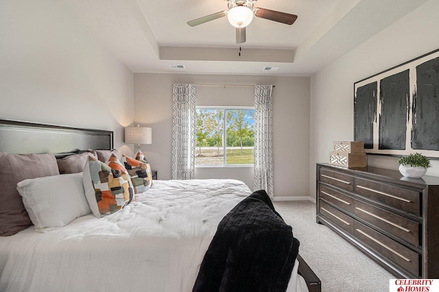 6413 N 168th Ave, Omaha, NE 68116 - bedroom with light colored carpet, a tray ceiling, a ceiling fan, and baseboards
