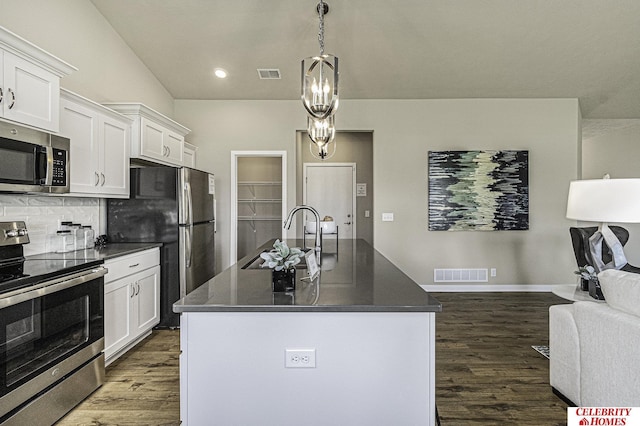6405 N 168th Ave, Omaha, NE 68116 - kitchen featuring appliances with stainless steel finishes, a sink, dark countertops, dark wood finished floors, and recessed lighting