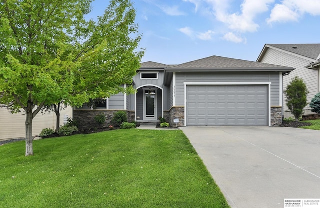 7211 S 174th St, Omaha, NE 68136 - view of front of house with stone siding, an attached garage, driveway, and a front lawn