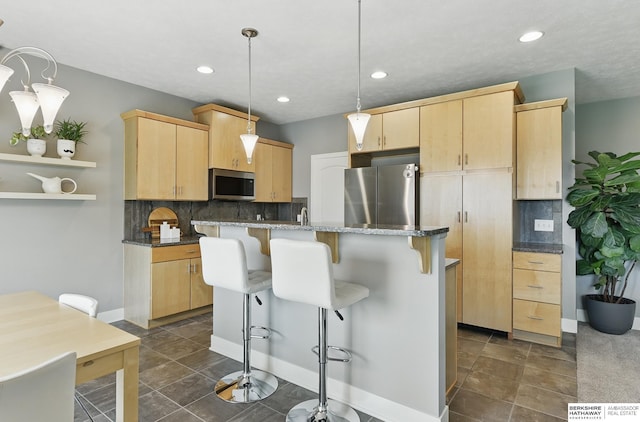 7211 S 174th St, Omaha, NE 68136 - kitchen featuring appliances with stainless steel finishes, light brown cabinetry, tasteful backsplash, and recessed lighting