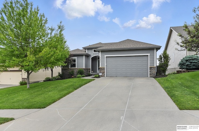 7211 S 174th St, Omaha, NE 68136 - prairie-style house featuring stone siding, an attached garage, a front lawn, and concrete driveway