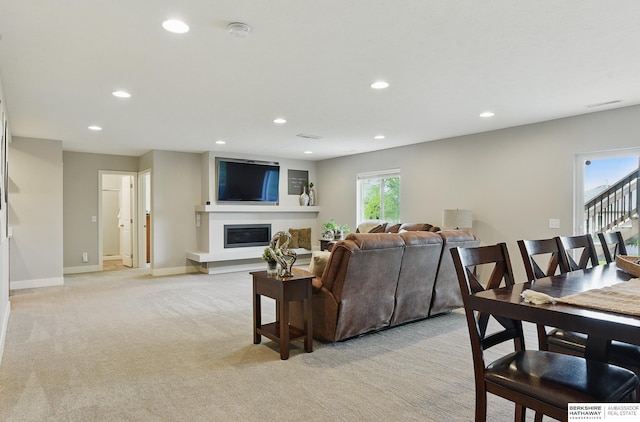 7211 S 174th St, Omaha, NE 68136 - living room featuring light colored carpet, recessed lighting, a glass covered fireplace, and baseboards