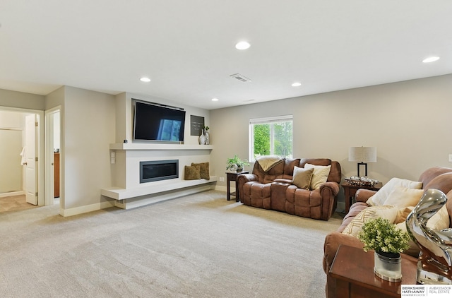 7211 S 174th St, Omaha, NE 68136 - living room featuring light colored carpet, recessed lighting, a glass covered fireplace, and baseboards