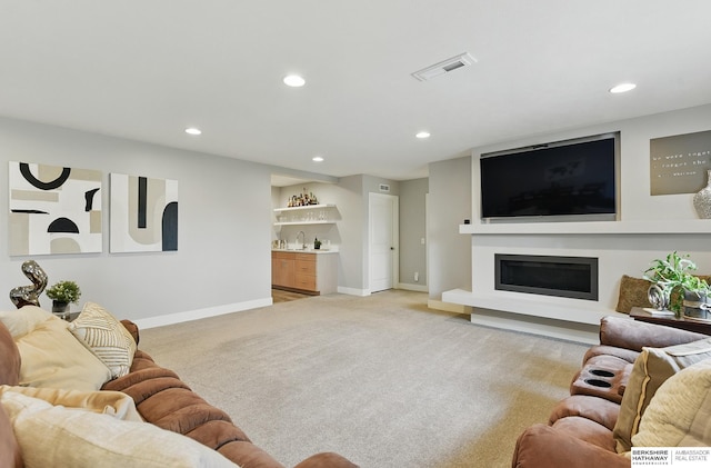 7211 S 174th St, Omaha, NE 68136 - living area featuring a dry bar, recessed lighting, light colored carpet, baseboards, and a glass covered fireplace