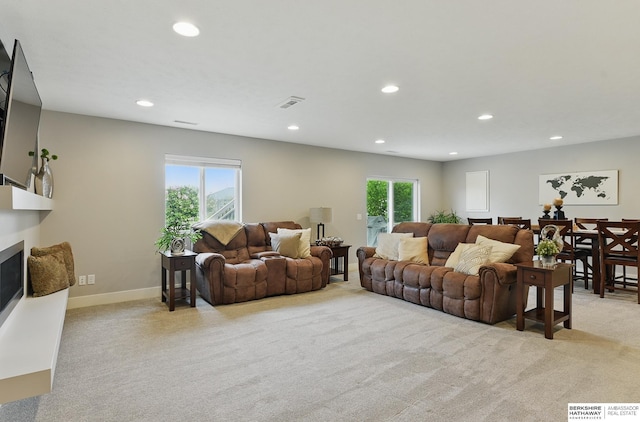 7211 S 174th St, Omaha, NE 68136 - living room with light colored carpet, recessed lighting, a glass covered fireplace, and baseboards
