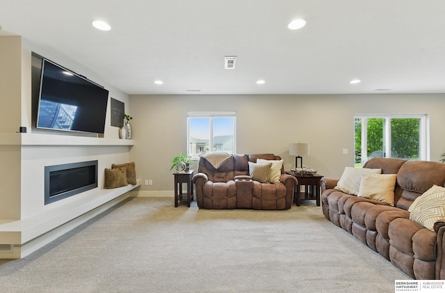 7211 S 174th St, Omaha, NE 68136 - carpeted living room with recessed lighting, a glass covered fireplace, and baseboards