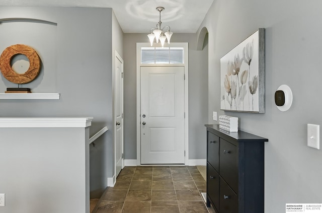 7211 S 174th St, Omaha, NE 68136 - entrance foyer with baseboards, a chandelier, and arched walkways