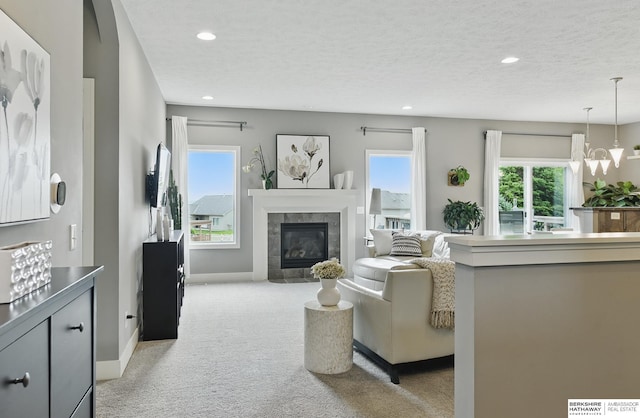 7211 S 174th St, Omaha, NE 68136 - living room with light carpet, plenty of natural light, recessed lighting, a chandelier, and a tile fireplace