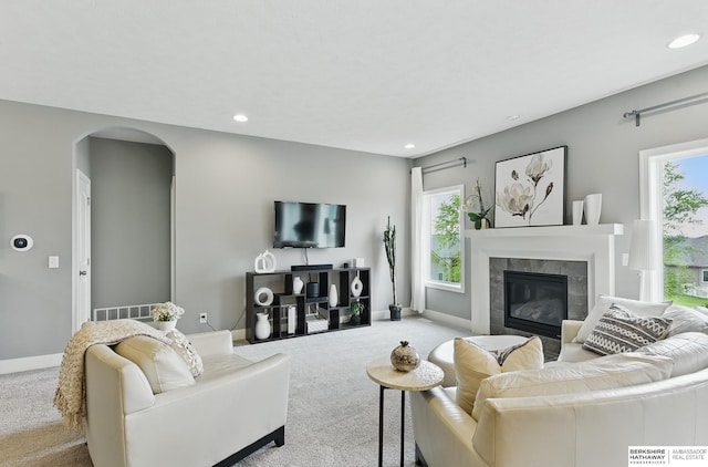 7211 S 174th St, Omaha, NE 68136 - carpeted living area featuring arched walkways, a fireplace, recessed lighting, and baseboards