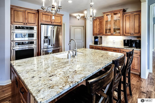 3400 Firethorn Ter, Lincoln, NE 68520 - kitchen with stainless steel fridge, a sink, brown cabinets, and dark wood-type flooring