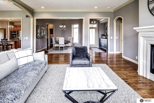 3400 Firethorn Ter, Lincoln, NE 68520 - living area with a chandelier, wood finished floors, arched walkways, crown molding, and baseboards