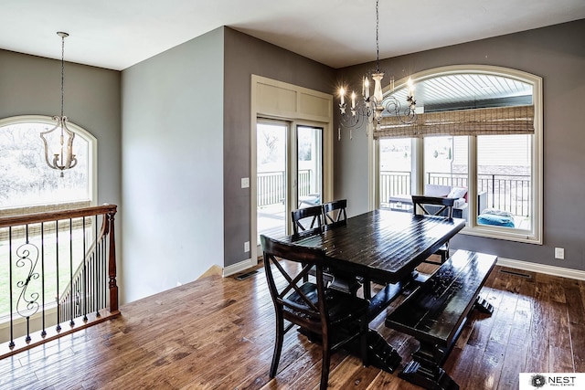 3400 Firethorn Ter, Lincoln, NE 68520 - dining room with a chandelier, hardwood / wood-style floors, and baseboards