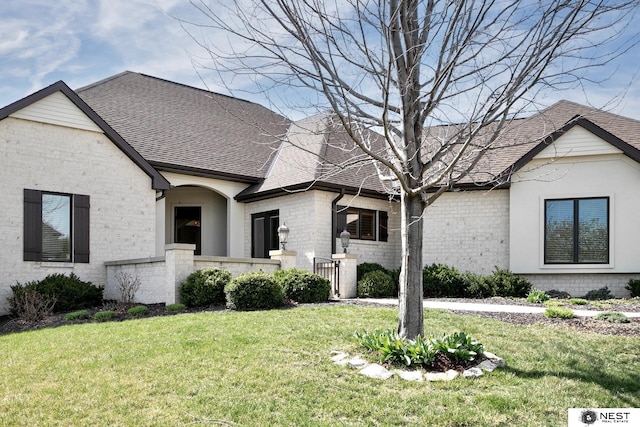 3400 Firethorn Ter, Lincoln, NE 68520 - french country inspired facade with roof with shingles, brick siding, and a front yard