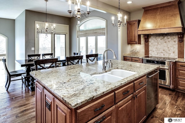 3400 Firethorn Ter, Lincoln, NE 68520 - kitchen featuring a sink, premium range hood, a chandelier, appliances with stainless steel finishes, and a center island with sink