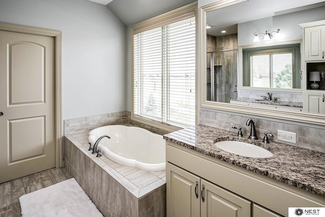3400 Firethorn Ter, Lincoln, NE 68520 - bathroom featuring a bath, healthy amount of natural light, a tile shower, and vanity