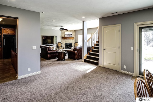 3400 Firethorn Ter, Lincoln, NE 68520 - living area with carpet flooring, a stone fireplace, stairway, baseboards, and a ceiling fan