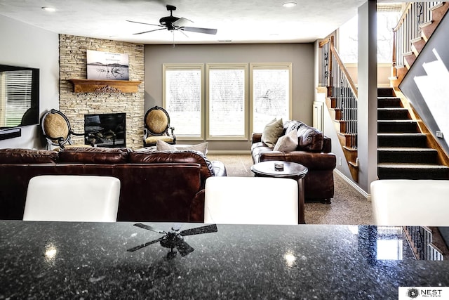 3400 Firethorn Ter, Lincoln, NE 68520 - carpeted living room featuring a ceiling fan, stairway, a fireplace, baseboards, and recessed lighting