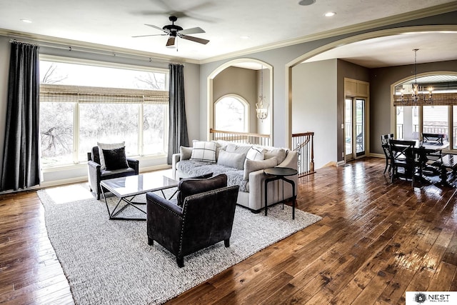 3400 Firethorn Ter, Lincoln, NE 68520 - living room featuring arched walkways, a chandelier, a ceiling fan, dark wood-style floors, and crown molding