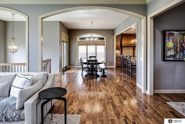 3400 Firethorn Ter, Lincoln, NE 68520 - dining room with a chandelier, arched walkways, hardwood / wood-style flooring, and baseboards