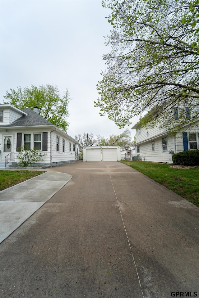 1822 N 60th St, Omaha, NE 68104 - view of property exterior featuring an outbuilding and a garage