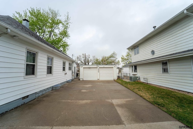 1822 N 60th St, Omaha, NE 68104 - view of home's exterior featuring an outdoor structure, central AC unit, and a detached garage