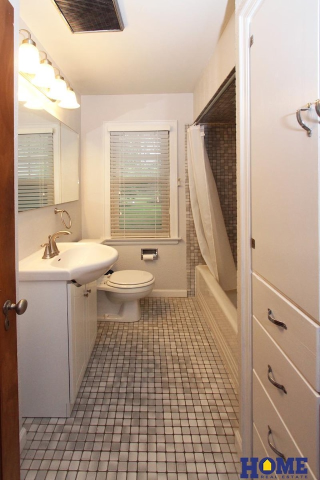 2727 S 19th St, Lincoln, NE 68502 - full bathroom featuring toilet, vanity, tile patterned floors, and shower / tub combo