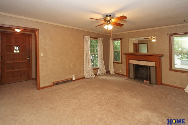 2727 S 19th St, Lincoln, NE 68502 - unfurnished living room featuring ceiling fan, carpet, plenty of natural light, a fireplace, and ornamental molding
