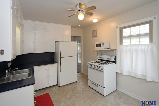 2727 S 19th St, Lincoln, NE 68502 - kitchen featuring white appliances, a sink, dark countertops, ceiling fan, and plenty of natural light