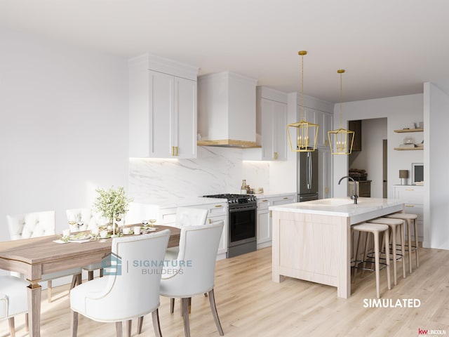 kitchen featuring appliances with stainless steel finishes, wall chimney exhaust hood, a sink, backsplash, and white cabinetry