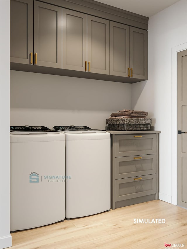 laundry area with separate washer and dryer, cabinet space, and light wood-style floors