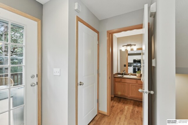 6031 N 167th Ct, Omaha, NE 68116 - corridor featuring light wood-type flooring and a sink